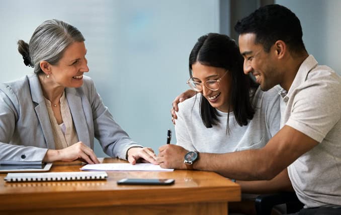 young couple completing paperwork for Arizona down payment assistance programs